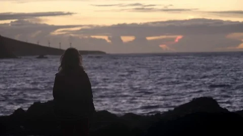 Sunset, waves, splashes and the girl enjoys the beauty of nature Stock-Footage 79823089