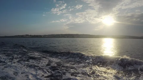 Sunset on waving sea, view from deck of moving ship Stock Footage 95700860
