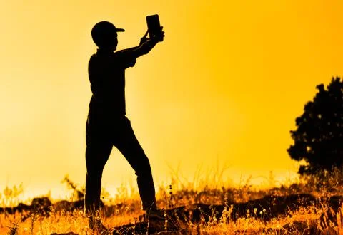 Sunset while taking selfie silhoutte Stock Photos