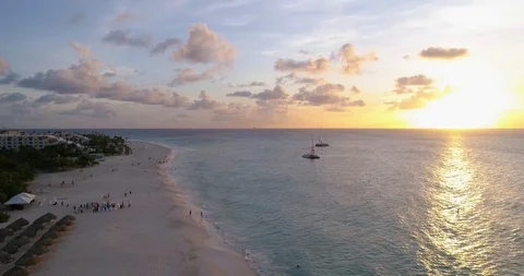 Sunset white beach with gazebos easy side turn flying high Stock-Footage 97150009