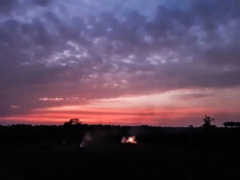 At sunset, the white clouds in the blue sky, the sun's light turned red and s Stock Photos