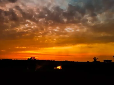 At sunset, the white clouds in the blue sky, the sun's light turned red and s Stock Photos