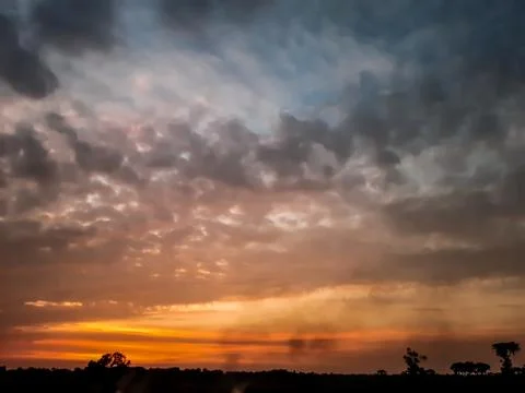 At sunset, the white clouds in the blue sky, the sun's light turned red and s Stock Photos