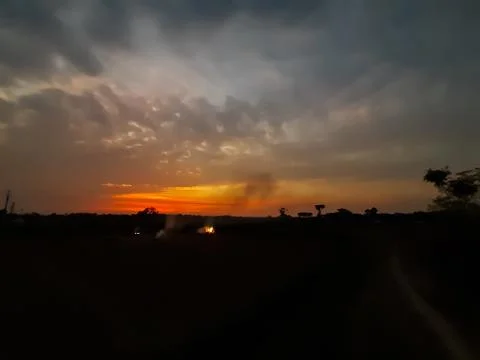 At sunset, the white clouds in the blue sky, the sun's light turned red and s Stock Photos