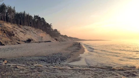 Sunset on wide, sandy beach. Small creek in the foreground Stock Footage 92048095