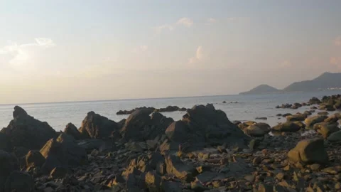Sunset on a wild beach with rocks at the water's edge, in Cambodia Stock Footage 236165842