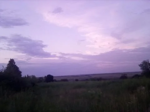 Sunset in a wild field Stock Photos