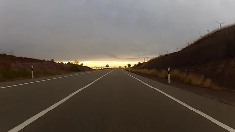 Sunset windmill drive Stock Footage 78037600