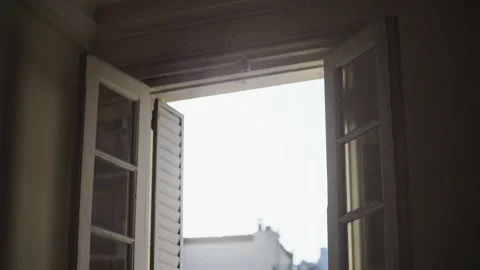 Sunset window with warm rays of light highlighting floating dust particles. Stock Footage 315007698