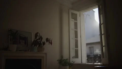 Sunset window with warm rays of light highlighting floating dust particles. Stock Footage 315007699