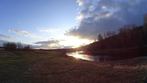 Sunset. Winter evening by the river Stock Photos