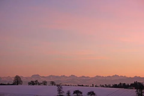 Sunset in winter with mountains in the background Stock Photos