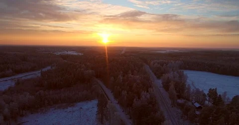 Sunset at a winter pond, Cinema 4k aerial sideway view over train tracks and  Stock Footage 85203524