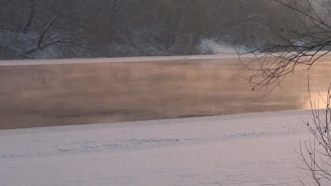 Sunset on a winter river, steam over the water, cormorant, fantasy. Stockbeeldmateriaal 326952480