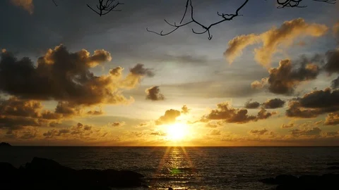 Sunset yellow gold beam light cloudy sky  into the sea with silhouette dry br Stock Footage 95654428