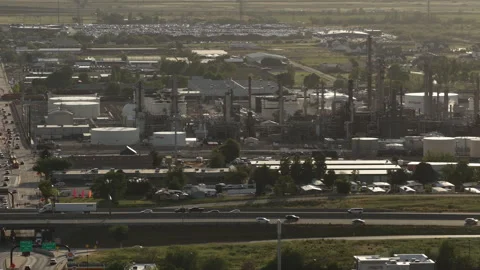 Sunset zoom aerial of Interstate 15 through Bountiful Utah with industrial plant Stock Footage 335724149