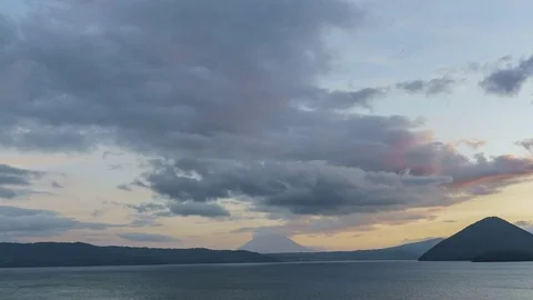 Sunset zoom out motion timelapse of the famous Lake Toya with Mount Yotei Stock Footage