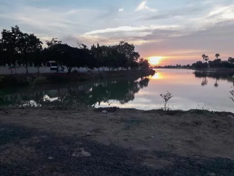 Sunsets behind the pond. Stock Photos