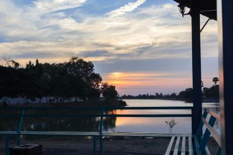 Sunsets behind the pond. Stock Photos