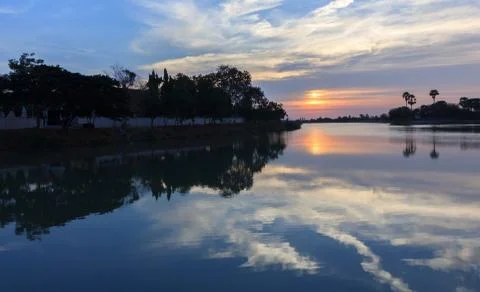 Sunsets behind the pond. Stock Photos