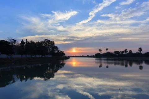 Sunsets behind the pond. Stock Photos