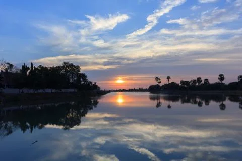 Sunsets behind the pond. Stock Photos