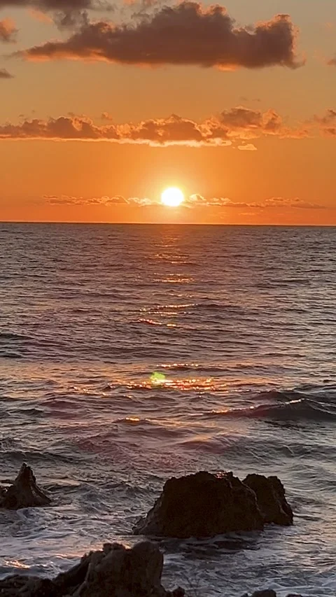 Sunsets Over the Ocean Create Breathtaking Views in a Tranquil Seaside Location Stock Footage 318389441