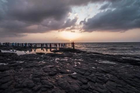Sunsets over a rocky beach in Mumbai Stock Photos