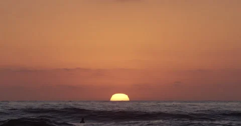 Sunsetting on the beach with waves Stock Footage 68555616