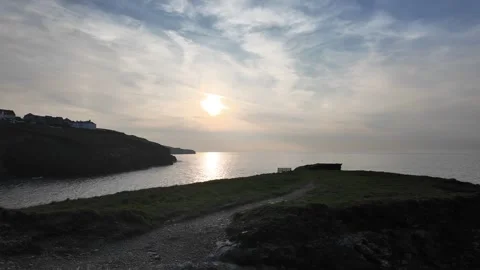 Sunsetting on the coast with path and bench Stock Footage 274752751