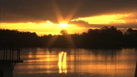 Sunsetting over trees in the distance Stock Footage 74096844