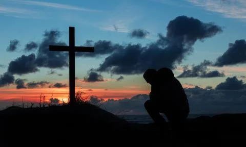 Sunsetting praying man cross Stock Photos