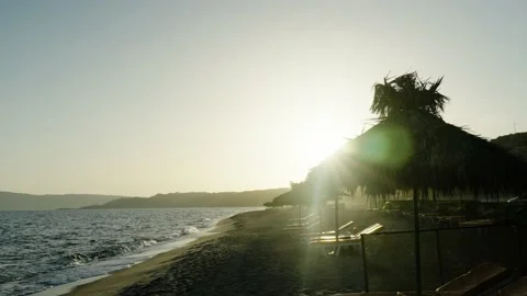 Sunshade on a beach in sunset Stock Footage 221784860