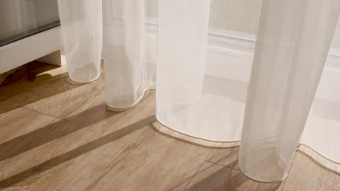 Sunshine and wind blows through the open window in the room. Sun and shadows Video stock 204121139