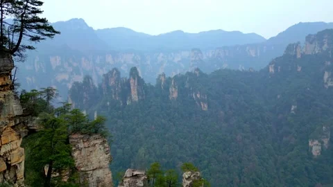 Sunshine Bathes Pillars with View Of karst Layered Avatar Mountains And Distant 库存影片 339334778