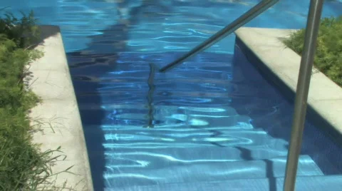 Sunshine beaming off rippling waves in crystal clear pool Stock Footage 117070