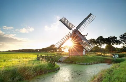 Sunshine behind Dutch windmill Stock Photos