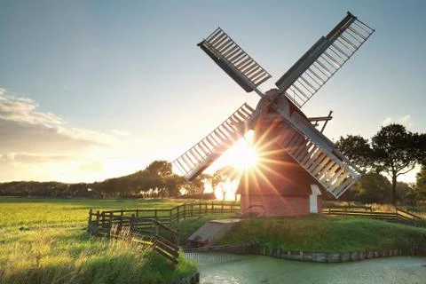 Sunshine behind Dutch windmill Stock Photos
