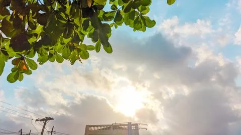 Sunshine breaking through white clouds Stock Photos