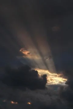 Sunshine coming through the clouds illuminating the clouds Stock Photos