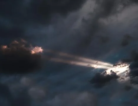 Sunshine coming through the clouds illuminating the clouds Stock Photos