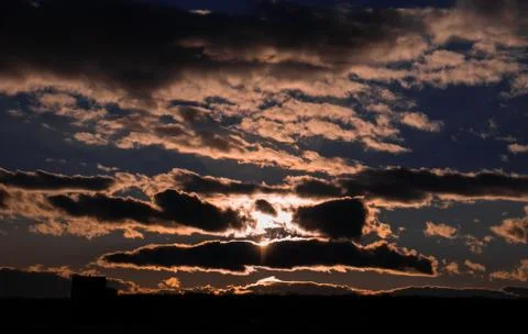 Sunshine coming through the clouds illuminating the clouds Stock Photos