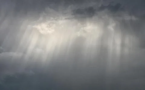 Sunshine coming through the gray clouds. Stock Photos
