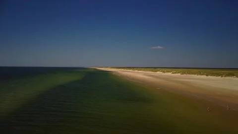 Sunshine day at the beach with clear water and sandy shore in the early aft.. Stock Footage 339936588