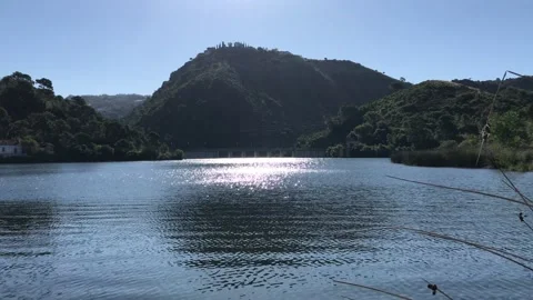 Sunshine on the lake surface surrounded by beautiful mountainous Stock Footage 132509941