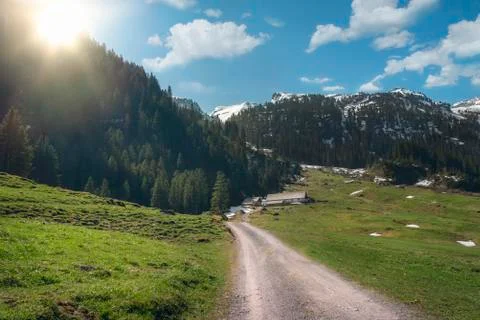 Sunshine over Alps mountains in spring Stock Photos