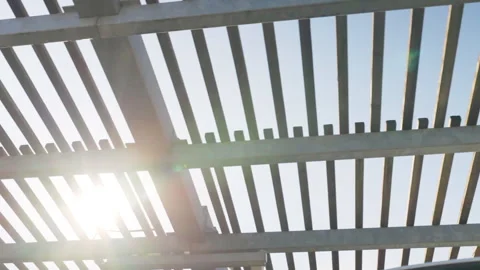 Sunshine passing through the metal construction frame being cover for parking Stock-Footage 305248290