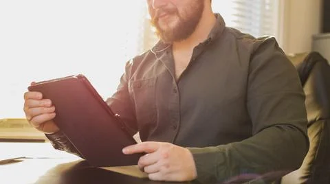 Sunshine portrait of boss using tablet at cabinet. Фото