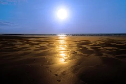 Sunshine reflected on a golden beach Stock Photos