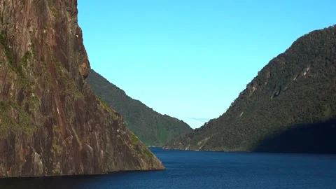Sunshine sea trip between the high mountains of new zealand Milford Sound Stock Footage 132062491
